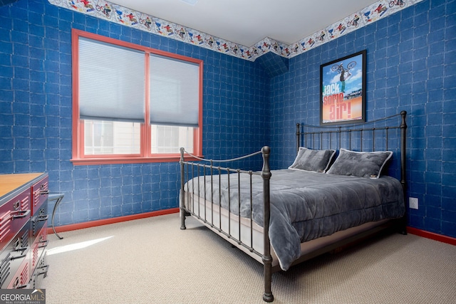 bedroom featuring carpet and baseboards