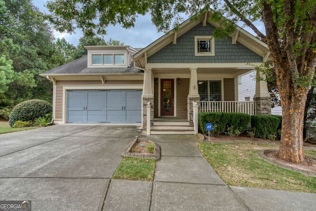 craftsman-style house featuring a porch and concrete driveway