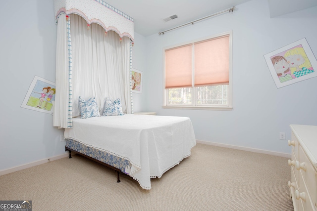 bedroom featuring baseboards, visible vents, and light colored carpet