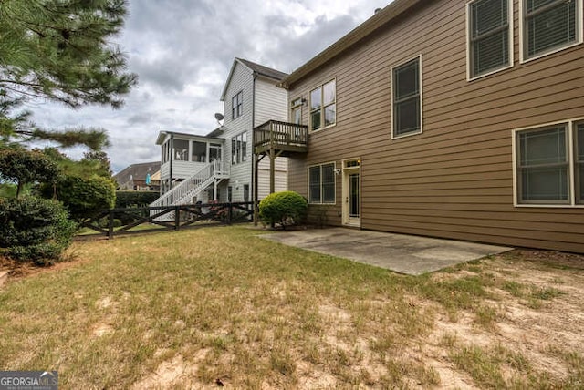 view of yard with a sunroom, a patio, and stairway