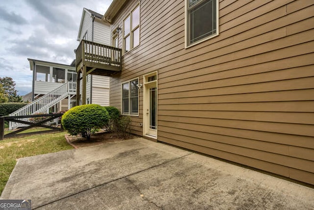 view of home's exterior with a patio area and a balcony