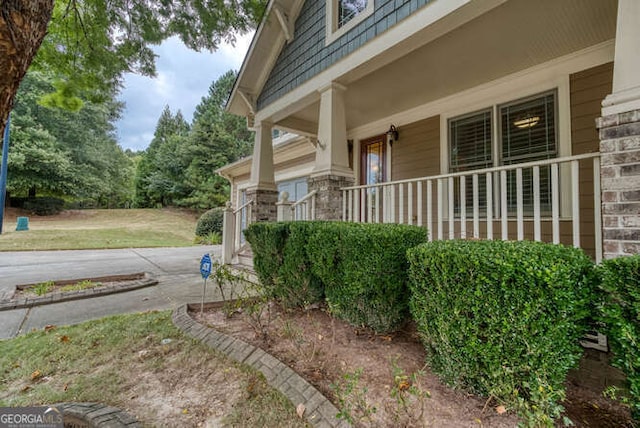 view of property exterior featuring covered porch