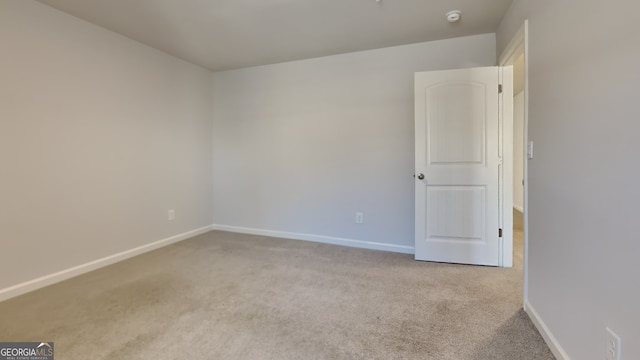 unfurnished room with light colored carpet