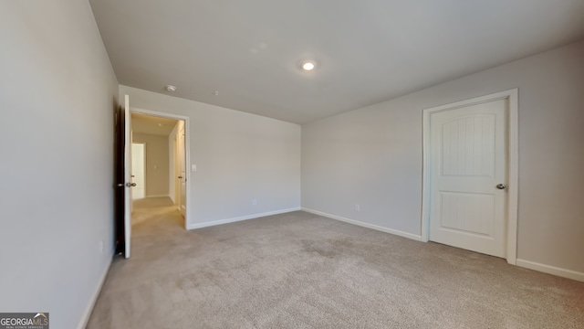 unfurnished room featuring light colored carpet