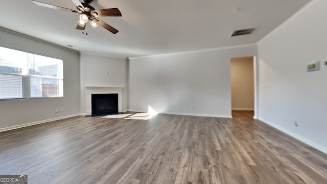 unfurnished living room featuring ceiling fan, ornamental molding, and hardwood / wood-style floors