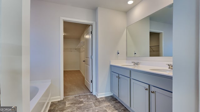 bathroom with vanity and a tub to relax in