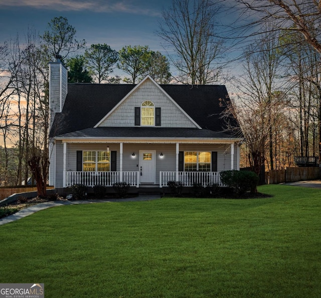 view of front of home with a lawn and covered porch