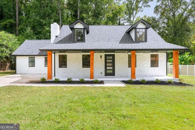 view of front of property with a front yard and covered porch