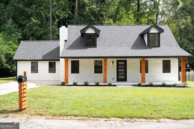 view of front of house with a porch and a front yard