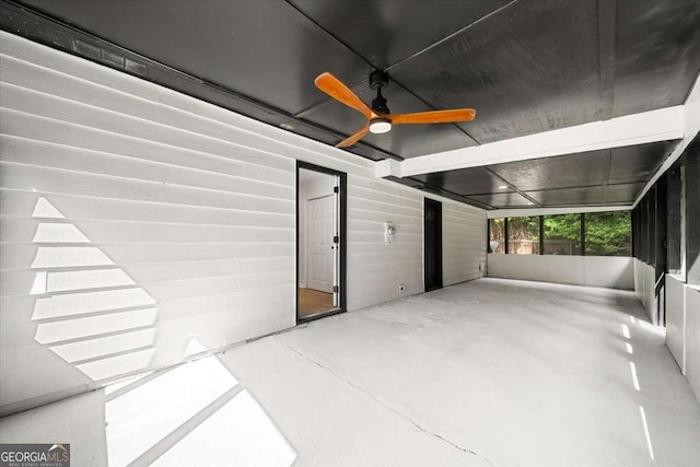 interior space featuring concrete flooring and ceiling fan