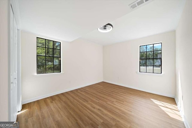 spare room with light wood-type flooring