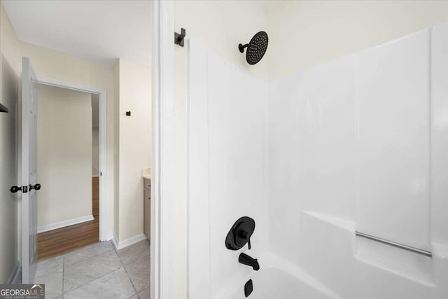 bathroom with shower / bath combination, vanity, and tile patterned flooring