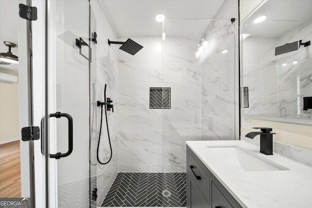 bathroom with hardwood / wood-style flooring, vanity, and a shower with shower door