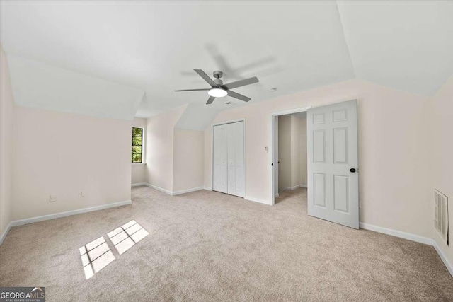 bonus room with ceiling fan, vaulted ceiling, and light carpet