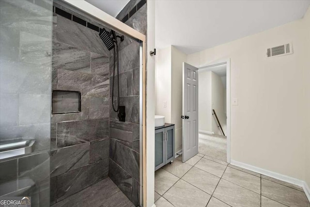 bathroom with tile patterned floors and tiled shower