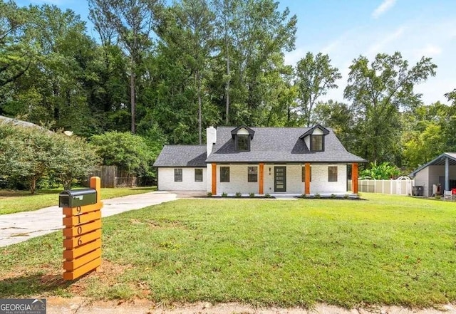 cape cod home with a front yard