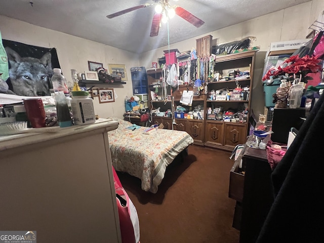 bedroom featuring ceiling fan, a textured ceiling, and carpet