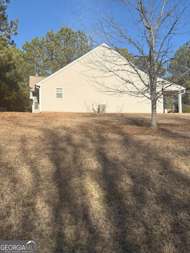 view of home's exterior with a yard