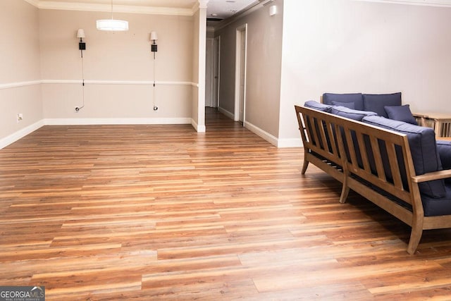 bedroom with ornamental molding and light wood-type flooring