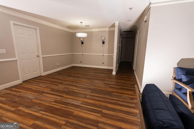 spare room featuring ornamental molding and dark hardwood / wood-style flooring