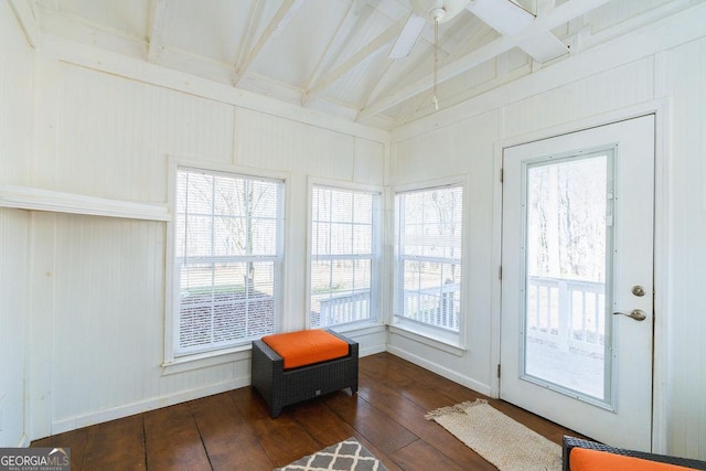 sunroom featuring vaulted ceiling with beams