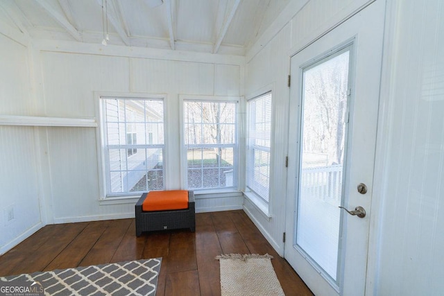 sunroom featuring beam ceiling