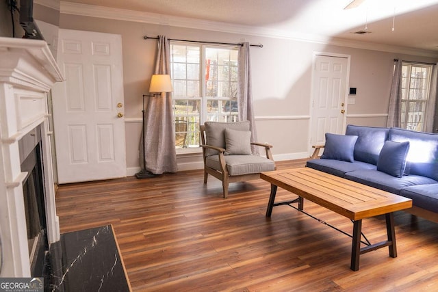 living room with ornamental molding, dark hardwood / wood-style floors, and a premium fireplace