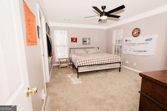 bedroom with crown molding, light carpet, and ceiling fan