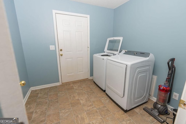 clothes washing area featuring washer and clothes dryer