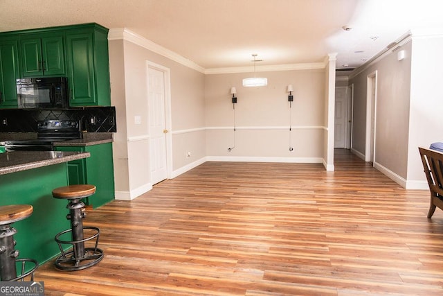 kitchen featuring green cabinets, light wood-type flooring, decorative backsplash, and black appliances