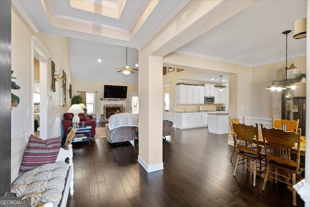 interior space featuring crown molding, ceiling fan, and dark hardwood / wood-style flooring