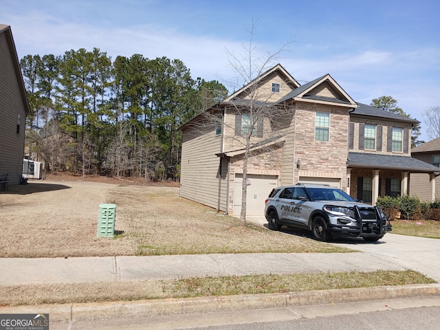 284 Madison Grace Ave, Mcdonough, GA 30252 - view of side of home with a garage, driveway, and stone siding