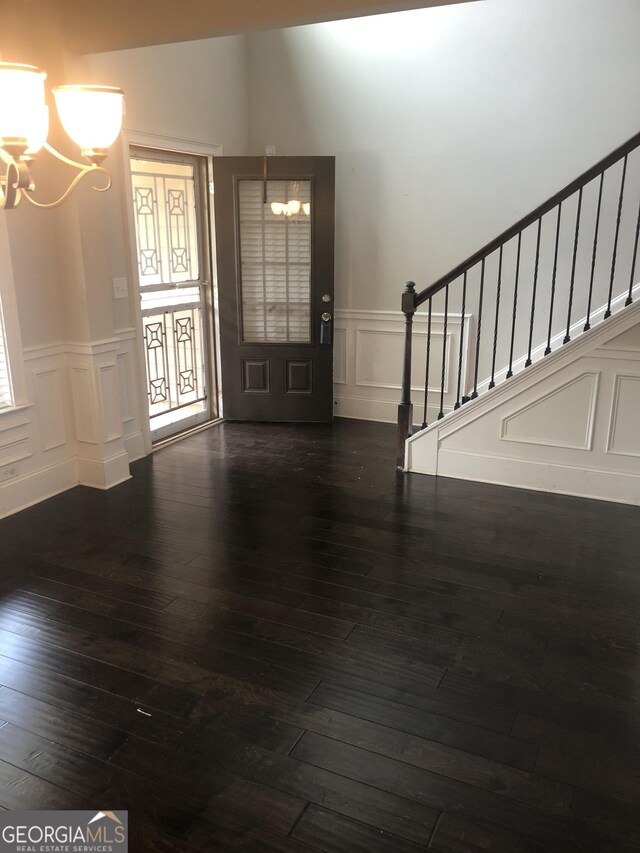 284 Madison Grace Ave, Mcdonough, GA 30252 - foyer with a chandelier, a decorative wall, stairway, hardwood / wood-style floors, and wainscoting