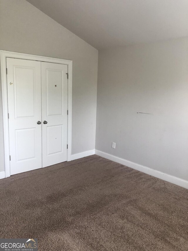 284 Madison Grace Ave, Mcdonough, GA 30252 - unfurnished bedroom featuring carpet, baseboards, and vaulted ceiling