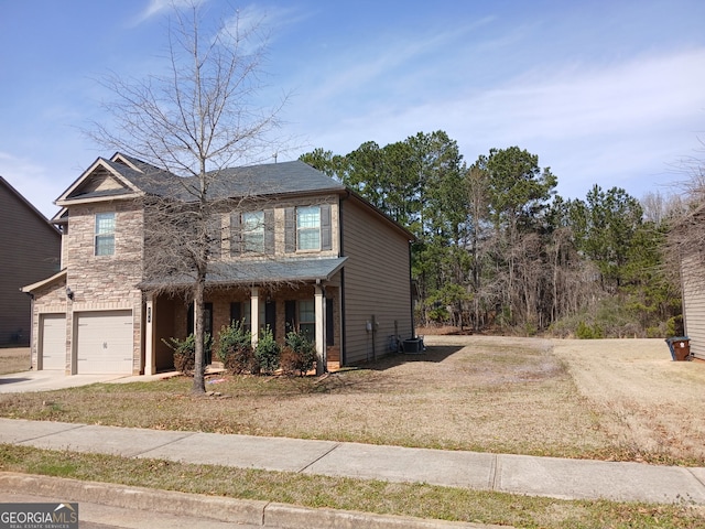 traditional-style home featuring driveway, central AC unit, stone siding, an attached garage, and a front lawn