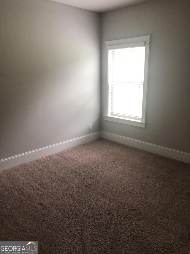 284 Madison Grace Ave, Mcdonough, GA 30252 - carpeted empty room with baseboards