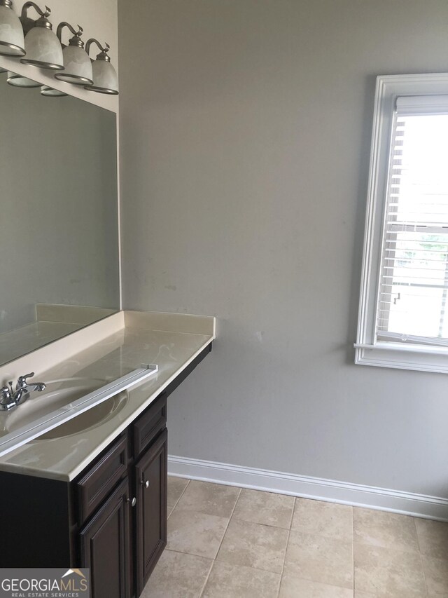 284 Madison Grace Ave, Mcdonough, GA 30252 - bathroom with baseboards, vanity, and tile patterned floors