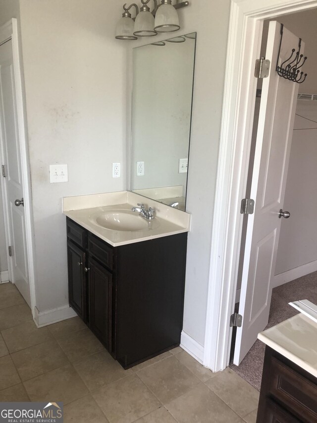284 Madison Grace Ave, Mcdonough, GA 30252 - bathroom featuring vanity, baseboards, and tile patterned floors