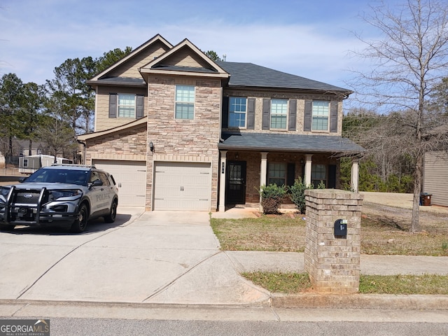 craftsman-style house with a garage, driveway, roof with shingles, and stone siding