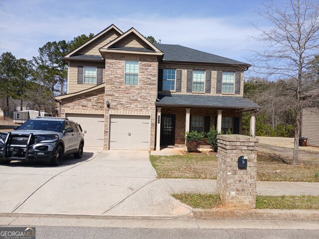 284 Madison Grace Ave, Mcdonough, GA 30252 - craftsman house featuring concrete driveway, a garage, stone siding, and a shingled roof