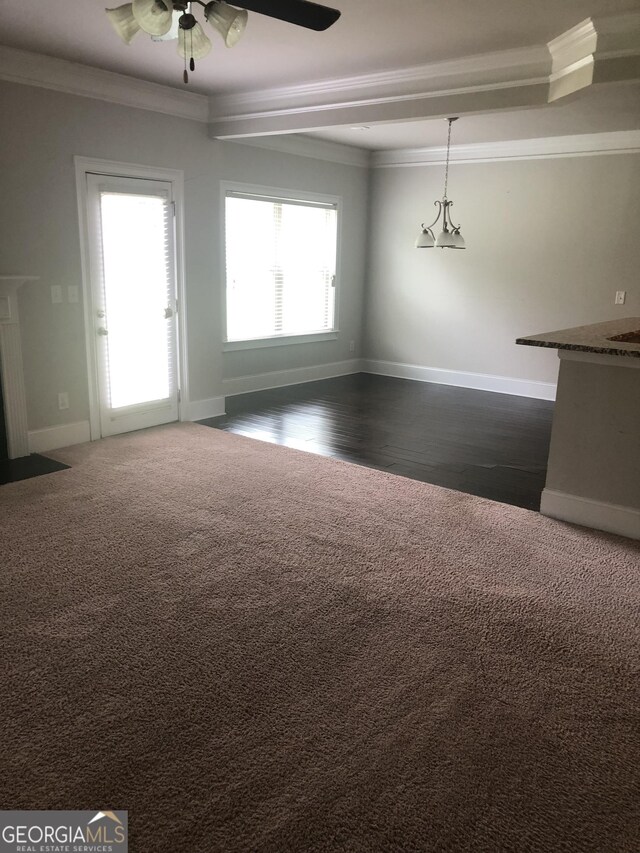 284 Madison Grace Ave, Mcdonough, GA 30252 - unfurnished dining area featuring ornamental molding, a ceiling fan, healthy amount of natural light, baseboards, and dark wood-type flooring