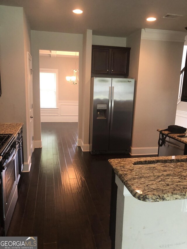 284 Madison Grace Ave, Mcdonough, GA 30252 - kitchen with appliances with stainless steel finishes, dark wood-style floors, dark brown cabinets, stone countertops, and wainscoting