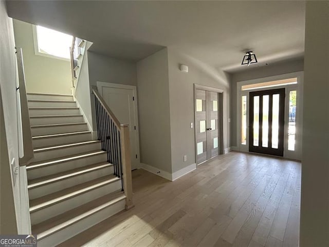 foyer entrance with light hardwood / wood-style floors