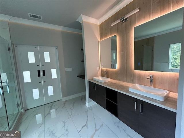 bathroom with crown molding, vanity, and walk in shower