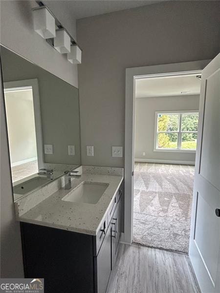 bathroom featuring vanity and wood-type flooring