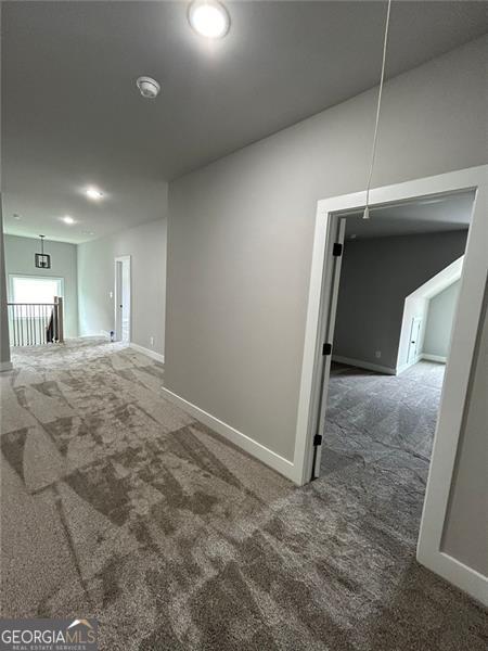 empty room featuring dark carpet