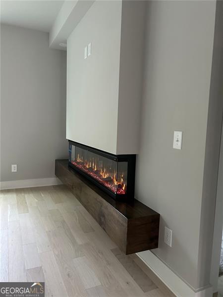 interior details featuring hardwood / wood-style floors and a multi sided fireplace