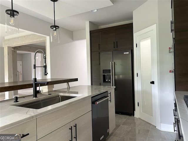 kitchen with high end fridge, sink, hanging light fixtures, dishwasher, and light stone countertops