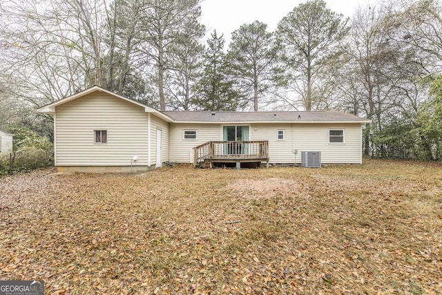 back of property with central AC and a deck