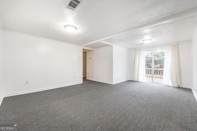 unfurnished room with a textured ceiling and dark colored carpet